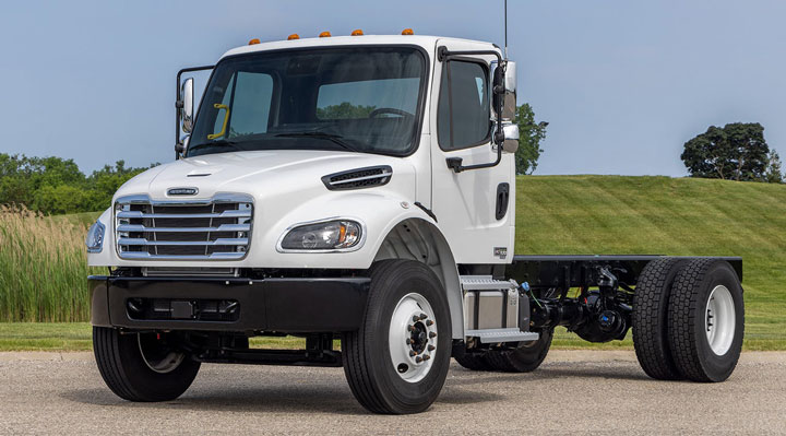 A white truck is parked on the side of the road.