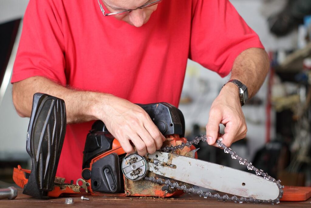 A man is using an electric saw to cut wood.